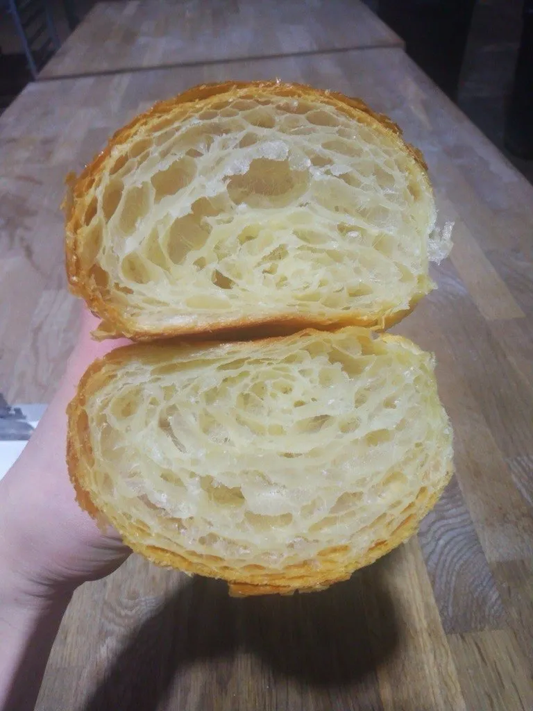 A croissant cut open to show the layers